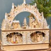 14.75" Lighted Laser Cut Wood Village Scene with Moving Figurine and Candles